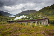 The Jacobite steam train passing over the Glenfinnan Viaduct at the head of Loch Shiel, Lochaber, Highlands of Scotland
