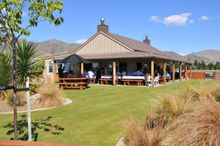 Wooing Tree Vineyard's tasting room is a great place to sample exquisite Central Otago wine and enjoy the stunning view.
