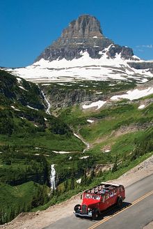 A red bus tour takes visitors through Glacier National Park.