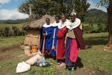 Maasai women in Tanzania welcoming G Adventures travelers