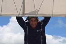 Tour guide Dustyn Currie shares cultural information with passengers aboard Hervey Bay Eco Marine Tour's glass-bottomed vessel Milbi.