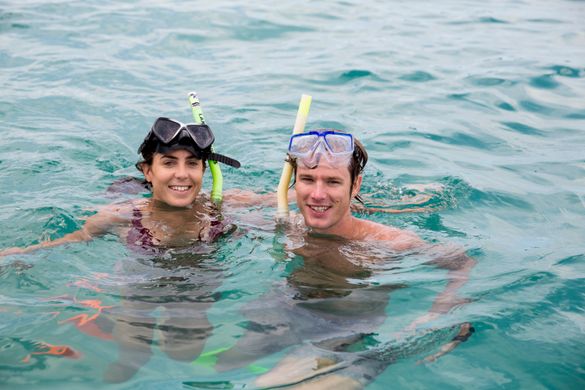 Ashleigh Gentle and Josh Amberger get ready to snorkel in the aquamarine waters off Tangalooma Resort on Moreton Island.