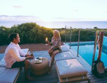 Walk into Luxury guests relaxing post-walk in their private pool villa accommodation on the Cape to Cape Track