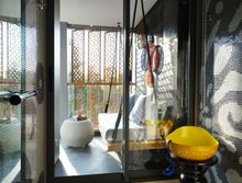 Tiled walls and balcony’s shades inspired by the traditional Songket textile art in bathrooms 