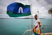 Phillip Takai-Bowie carries the Queen’s Baton on board the ferry to Thursday Island as it touched down in Queensland on Saturday, March 3 on the final leg of its worldwide journey to the Opening Ceremony on the Gold Coast on April 4. 