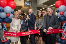 Ribbon cut in Austin. From left: Karen Bell, British Consul General; Norwegian crewmembers; Anders Lindström, Director of Communications, Norwegian; Erin Nemeth, Visit Britain PR&Marketing Manager.; and Austin City Council Member Jimmy Flannigan.