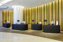 green wall with preseved moss and reception desks