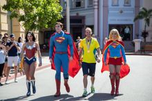 Commonwealth Games Gold medalist Steele Von Hoff takes a walk with Movie World superheroes