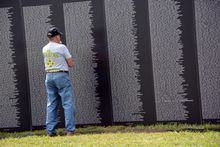 A veteran remembers at the American Traveling Tribute Wall during Clarksville's Welcome Home Veterans Celebration.