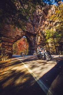 Motorcycle riders pass Backbone Rock in Johnson County Tennessee