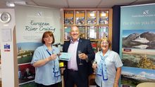 Andrea Dixon, left, is presented with her free cruise voucher by Head of Sales at Fred. Olsen Cruise Lines, Mike Evans, alongside Isabelle Bending of Broad’s Travel in Sutton Coldfield.