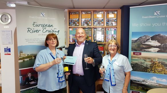 Andrea Dixon, left, is presented with her free cruise voucher by Head of Sales at Fred. Olsen Cruise Lines, Mike Evans, alongside Isabelle Bending of Broad’s Travel in Sutton Coldfield.