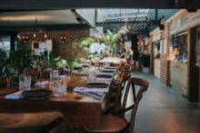 The Collective Palm Beach interior withlong table and chairs set up for meals