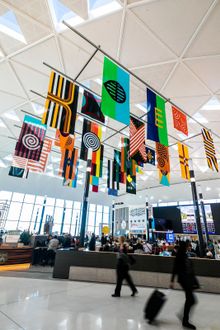Archie  Moore,   United  Neytions ,  2018 ,   i nstallation  for  T1  Interna tional   Terminal,  Sydney  Airport,   MCA  &   Sydney  Airport   Commission ,  2018 , photograph : Anna Kucera