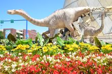 Adult Alamasaur dinosaur: 54-foot-long and youth dinosaurs: 34-foot-long each bursting out of the building