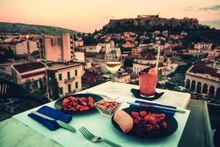 Dinner at a rooftop restaurant with views over the Acropolis