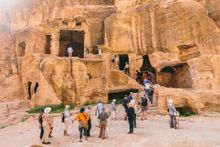 Travellers touring Siq al-Barid (or Little Petra) in Jordan