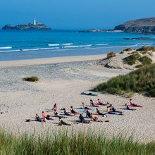 Yoga on the beach delivered by Alicia Ray Wellbeing