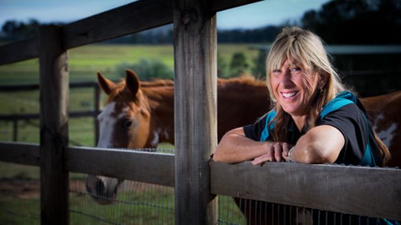 GOLDOC board member Glynis Nunn-Cearns is all smiles on her horse property at Mount Tambourine in the Gold Coast Hinterland.