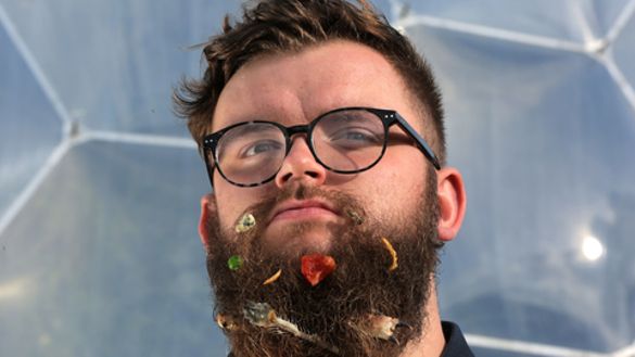 Inspired by Roald Dahl’s The Twits, Eden Project narrator Jake Proffitt poses with a beard full of discarded food including a sardine tail, some edible insects and a blob of Stilton cheese.