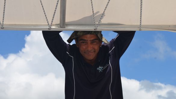 Tour guide Dustyn Currie shares cultural information with passengers aboard Hervey Bay Eco Marine Tour's glass-bottomed vessel Milbi.