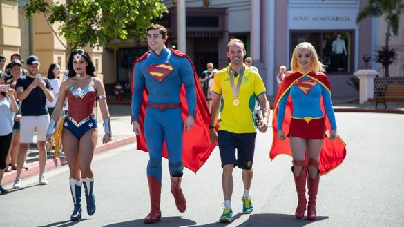 Commonwealth Games Gold medalist Steele Von Hoff takes a walk with Movie World superheroes