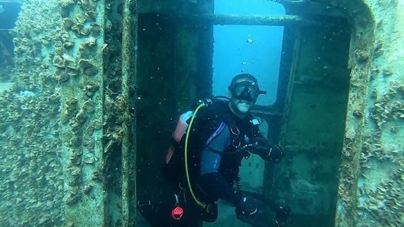 A Hervey Bay Dive Centre staff member has an early look at the ex-HMAS Tobruk wreck.