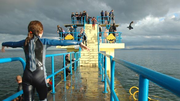 People jumping off the Blackrock diving board at the Salthill Promenade
