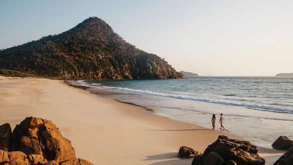 Couple enjoying a walk along Zenith Beach, Port Stephens