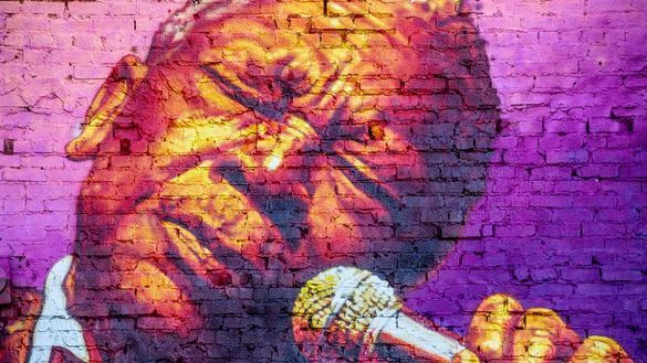 A vibrant Memphis mural of a B.B. King singing into a microphone. A vibrant Memphis mural of a B.B. King singing into a microphone.