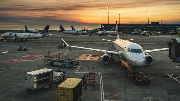 A commercial airplane parked at an airport gate.